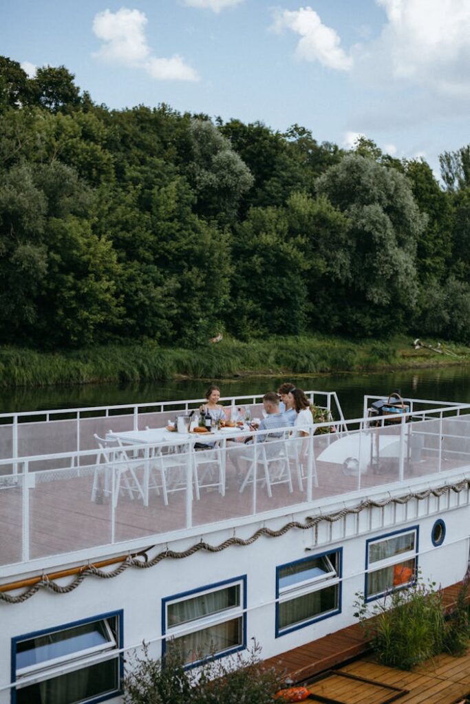 A group of friends enjoying a meal on a yacht during a summer day.